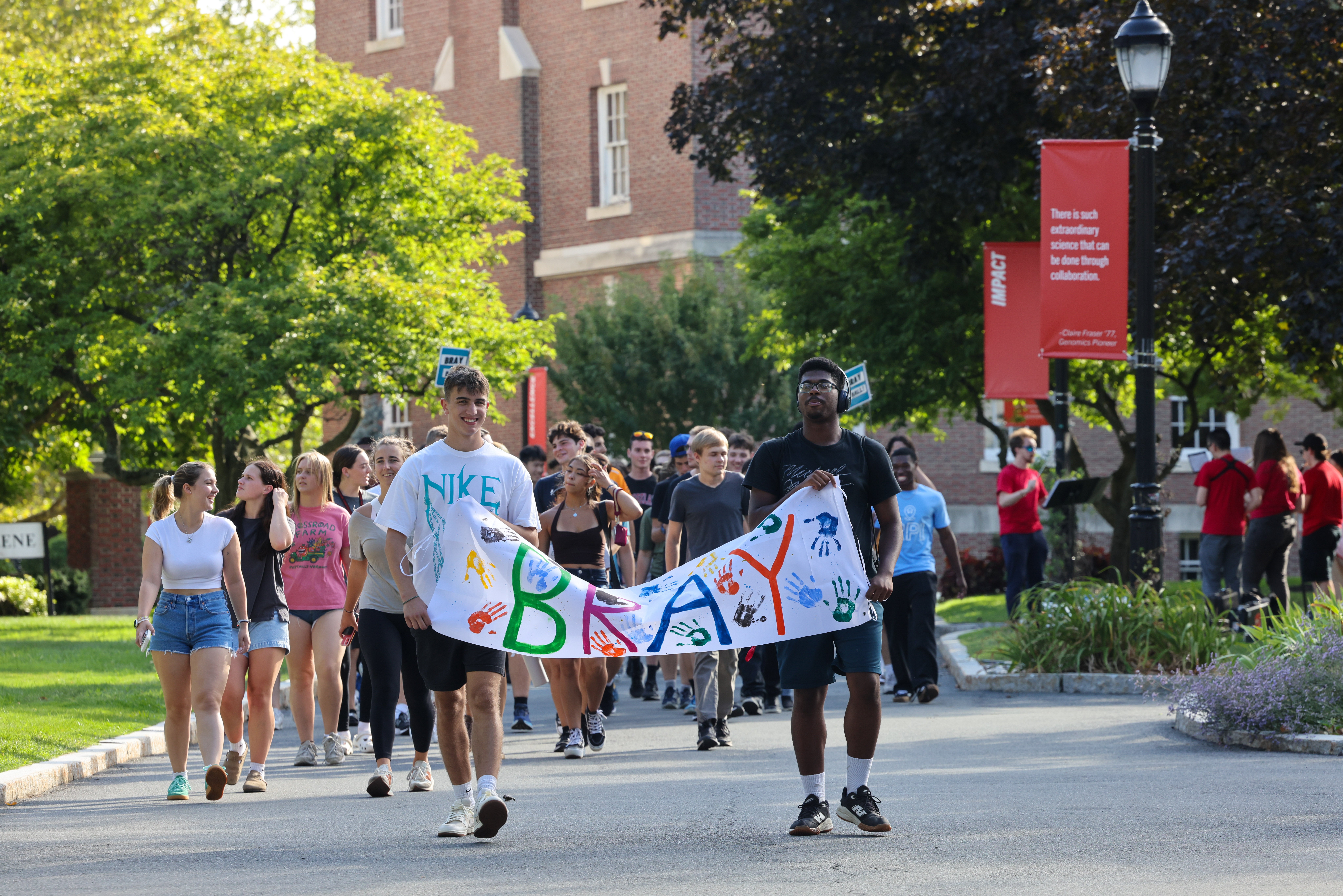 Students holding Bray residence hall banner 