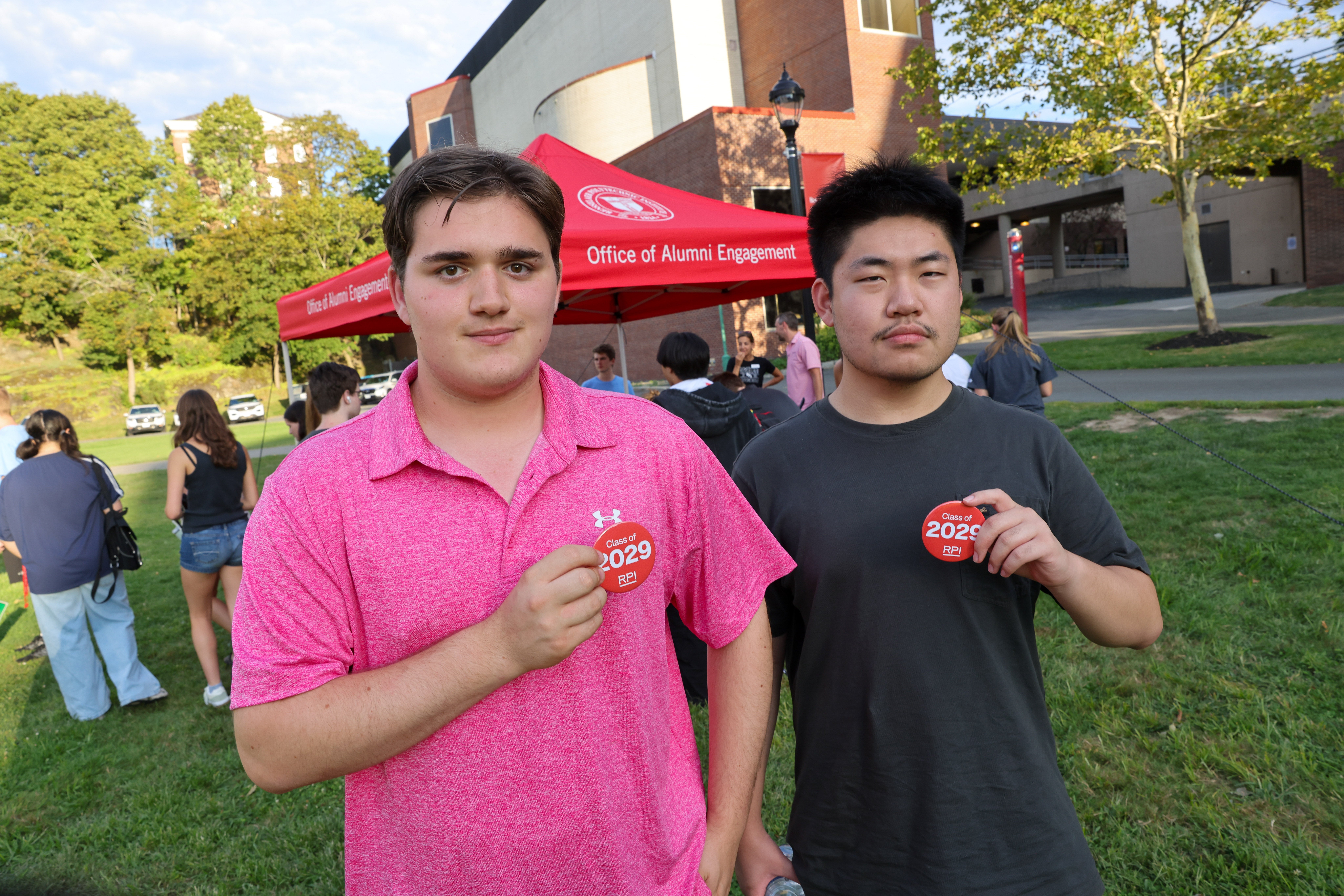 Two students holding class of 2029 pins