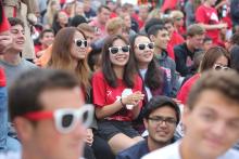 Three girls with RPI sunglasses on at an orientation event