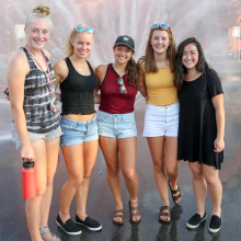 RPI students posting in front of sprinkler