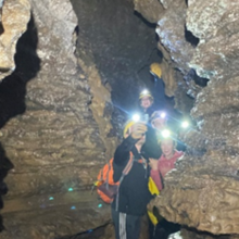 Students in Cave with Flashlights